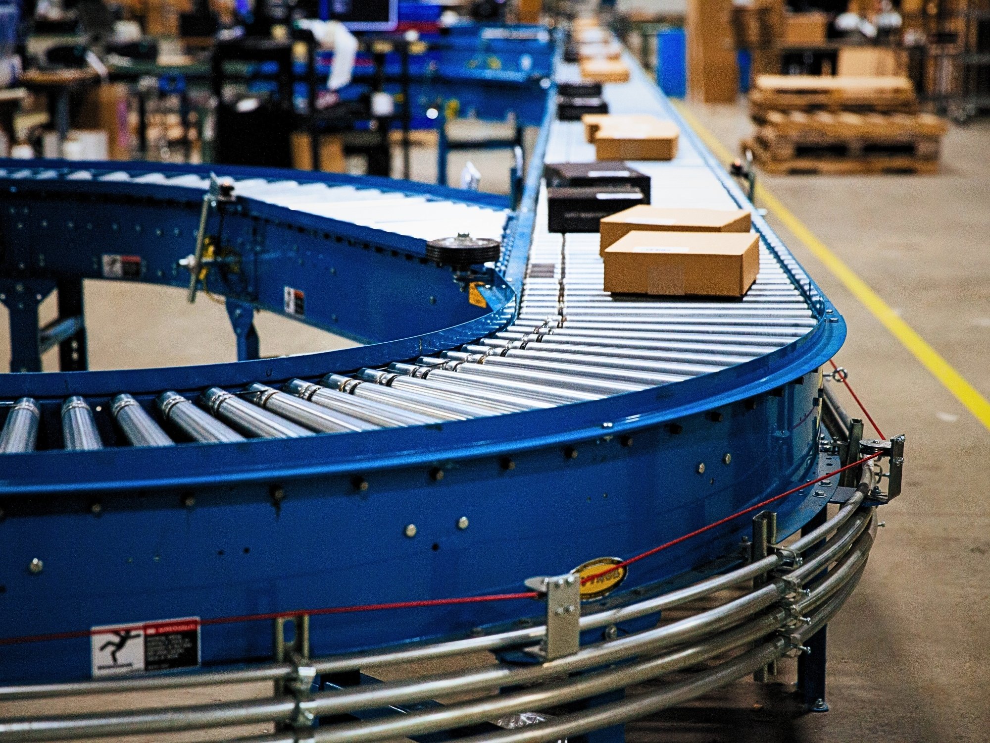 Cartons traveling around a roller conveyor curve